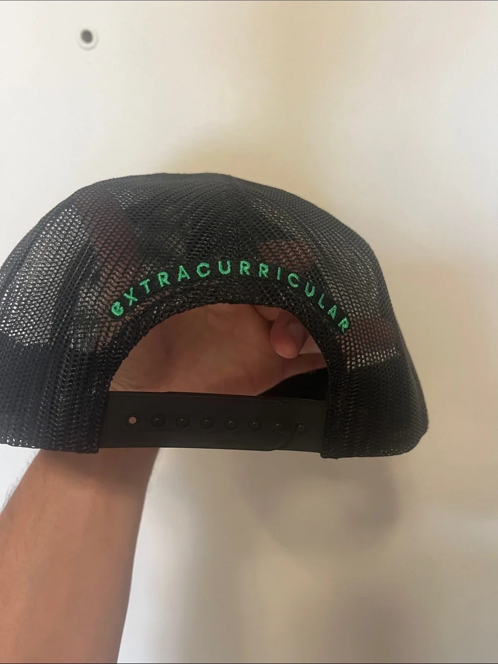 Extracurricular Black Mesh Trucker Cap with White Embroidered Logo